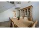 Cozy dining room with tile flooring, a view of the staircase, and warm lighting at 3816 E Phelps St, Gilbert, AZ 85295