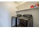 Laundry room features modern Samsung washer and dryer with shelving at 3816 E Phelps St, Gilbert, AZ 85295