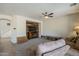 Cozy living room with carpet flooring, a ceiling fan, a sofa, and a TV at 3816 E Phelps St, Gilbert, AZ 85295