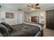 Main bedroom featuring neutral walls, a ceiling fan, and an impressive wood-frame bed set at 3816 E Phelps St, Gilbert, AZ 85295