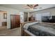 Main bedroom with ceiling fan, sliding barn door to ensuite bathroom, and ample storage at 3816 E Phelps St, Gilbert, AZ 85295