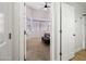 View of a bedroom through a doorway with a ceiling fan, bay window and neutral carpet at 417 S 89Th Way, Mesa, AZ 85208