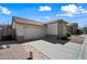 Charming single-story home with a tile roof, two car garage, and desert landscaping at 417 S 89Th Way, Mesa, AZ 85208