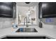 Close up of the kitchen sink, stainless steel faucet, and black cabinetry at 417 S 89Th Way, Mesa, AZ 85208