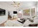 Bright living room boasts a ceiling fan, white couch, and sliding glass doors to the backyard at 417 S 89Th Way, Mesa, AZ 85208