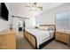 Comfortable main bedroom with a sliding barn door leading to the ensuite bathroom at 417 S 89Th Way, Mesa, AZ 85208