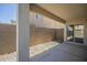 Covered back patio overlooking a gravel yard enclosed by a block wall at 4582 E Jadeite Dr, San Tan Valley, AZ 85143