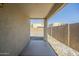 Covered back patio with concrete floor, leading to a gravel backyard and block wall at 4582 E Jadeite Dr, San Tan Valley, AZ 85143