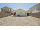 Gravel backyard enclosed with a block wall, featuring a covered patio and exterior utilities at 4582 E Jadeite Dr, San Tan Valley, AZ 85143