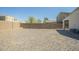 Wide view of gravel backyard enclosed with a block wall at 4582 E Jadeite Dr, San Tan Valley, AZ 85143