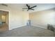 Neutral bedroom features plush carpeting, ceiling fan and doorway to another room at 4582 E Jadeite Dr, San Tan Valley, AZ 85143