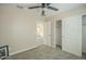 A neutral bedroom features plush carpeting, ceiling fan and a closet with sliding doors at 4582 E Jadeite Dr, San Tan Valley, AZ 85143