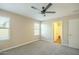 Bedroom offers ceiling fan, carpeting, light walls and a doorway to the bathroom at 4582 E Jadeite Dr, San Tan Valley, AZ 85143