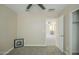 Neutral bedroom with ceiling fan, carpet, and doorway leading to another room at 4582 E Jadeite Dr, San Tan Valley, AZ 85143