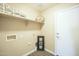 Well-lit laundry room with a shelf, electrical outlets, and white door at 4582 E Jadeite Dr, San Tan Valley, AZ 85143