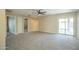 Spacious living room featuring neutral carpet, recessed lighting, and sliding glass doors to the backyard at 4582 E Jadeite Dr, San Tan Valley, AZ 85143