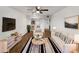 Bright living room featuring hardwood floors, a modern ceiling fan, and neutral-colored furniture with striped accents at 540 N May -- # 3131, Mesa, AZ 85201