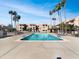 Inviting pool with lounge chairs, surrounded by mature palm trees in a landscaped community at 540 N May -- # 3131, Mesa, AZ 85201