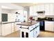 Bright kitchen featuring white cabinetry, a center island, and modern appliances at 5533 E Decatur St, Mesa, AZ 85205