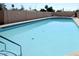 Large in-ground swimming pool featuring an expansive sun deck, ladder access, and stylish tile accents, perfect for recreation at 5533 E Decatur St, Mesa, AZ 85205