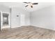 Living room with wood-look floors, ceiling fan and several entryways at 5625 W Euclid Ave, Laveen, AZ 85339