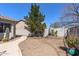 Desert landscaped backyard with gravel, pavers, a small tree, and a privacy wall at 7329 W Tether Trl, Peoria, AZ 85383