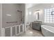 Modern bathroom with a soaking tub, walk-in shower, and grey vanity at 7329 W Tether Trl, Peoria, AZ 85383