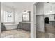 Elegant bathroom with soaking tub, walk-in closet, and grey vanity at 7329 W Tether Trl, Peoria, AZ 85383