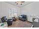 Bright Bedroom with a crib, armchair, and natural light from shuttered windows at 7329 W Tether Trl, Peoria, AZ 85383