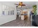 Dining area with tile floors, ceiling fan and adjacent kitchen with stainless steel appliances at 7329 W Tether Trl, Peoria, AZ 85383