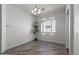 Dining area with a chandelier, shutters, and light wood-look floors at 7329 W Tether Trl, Peoria, AZ 85383