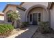 Close up of covered front entrance with desert landscaping, walkway and security door at 7329 W Tether Trl, Peoria, AZ 85383