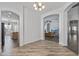 Hallway that has tile flooring and arches leading to the kitchen and living room at 7329 W Tether Trl, Peoria, AZ 85383