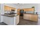 Bright kitchen with wooden cabinetry, stainless steel appliances, and stone countertops at 7329 W Tether Trl, Peoria, AZ 85383