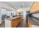 Open-concept kitchen featuring tile floors, granite countertops and stainless steel appliances at 7329 W Tether Trl, Peoria, AZ 85383