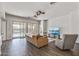 Bright living room with wood floors and sliding glass doors to pool at 7329 W Tether Trl, Peoria, AZ 85383