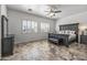 Large main bedroom features a ceiling fan and windows with plantation shutters at 7329 W Tether Trl, Peoria, AZ 85383