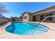 Sparkling private pool with steps, complemented by a well-maintained patio and landscaped backyard at 7329 W Tether Trl, Peoria, AZ 85383