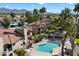 Aerial view of community pool, landscaping, and surrounding buildings in an apartment community at 9445 N 94Th Pl # 212, Scottsdale, AZ 85258