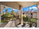 Balcony view of lush landscaping and nearby buildings in a garden-style apartment complex at 9445 N 94Th Pl # 212, Scottsdale, AZ 85258
