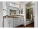Bathroom with double vanity, granite countertops, framed mirror, and a shower at 9445 N 94Th Pl # 212, Scottsdale, AZ 85258