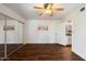 Bright bedroom with ceiling fan, mirrored closet doors, and ensuite bathroom at 9445 N 94Th Pl # 212, Scottsdale, AZ 85258