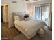 Comfortable bedroom featuring a large bed, neutral tones, and balcony access at 9445 N 94Th Pl # 212, Scottsdale, AZ 85258