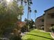 Exterior view featuring well-maintained landscaping, mature trees, and building facade at 9445 N 94Th Pl # 212, Scottsdale, AZ 85258