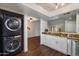 Updated kitchen with granite countertops, stainless steel appliances, and stackable washer and dryer at 9445 N 94Th Pl # 212, Scottsdale, AZ 85258