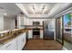Beautiful kitchen features white cabinets, stainless steel appliances, granite counters, and wood flooring at 9445 N 94Th Pl # 212, Scottsdale, AZ 85258