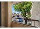 View from the patio of a parking lot surrounded by mature trees with a bright blue sky at 9445 N 94Th Pl # 212, Scottsdale, AZ 85258