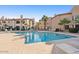Relaxing community pool with palm trees, lounge chairs, and well-maintained landscaping at 9445 N 94Th Pl # 212, Scottsdale, AZ 85258