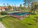 Scenic view of a community tennis court surrounded by trees and lush green lawns at 9445 N 94Th Pl # 212, Scottsdale, AZ 85258