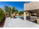 Inviting backyard with pool, lounge chairs, covered patio and lush landscaping at 11121 N 165Th Ave, Surprise, AZ 85388